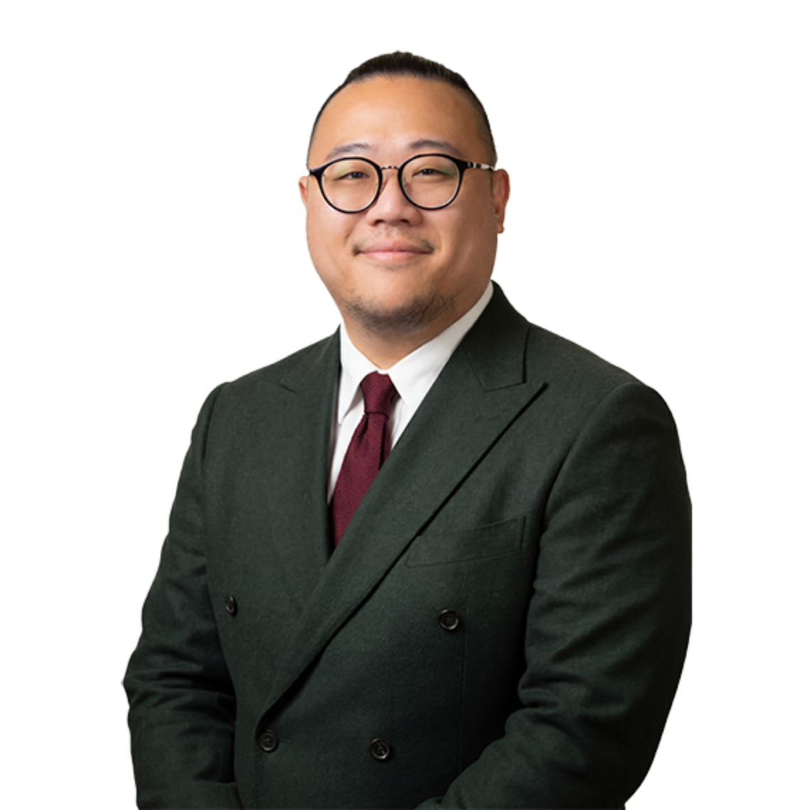 A professional studio portrait of Mr Chad Chang, a consultant surgeon specialising in lymphatic supermicrosurgery, wearing a dark green double-breasted suit, a white shirt, a maroon tie, and glasses.